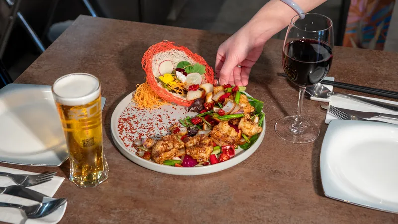 Chilli prawns being served, restaurant photography in London