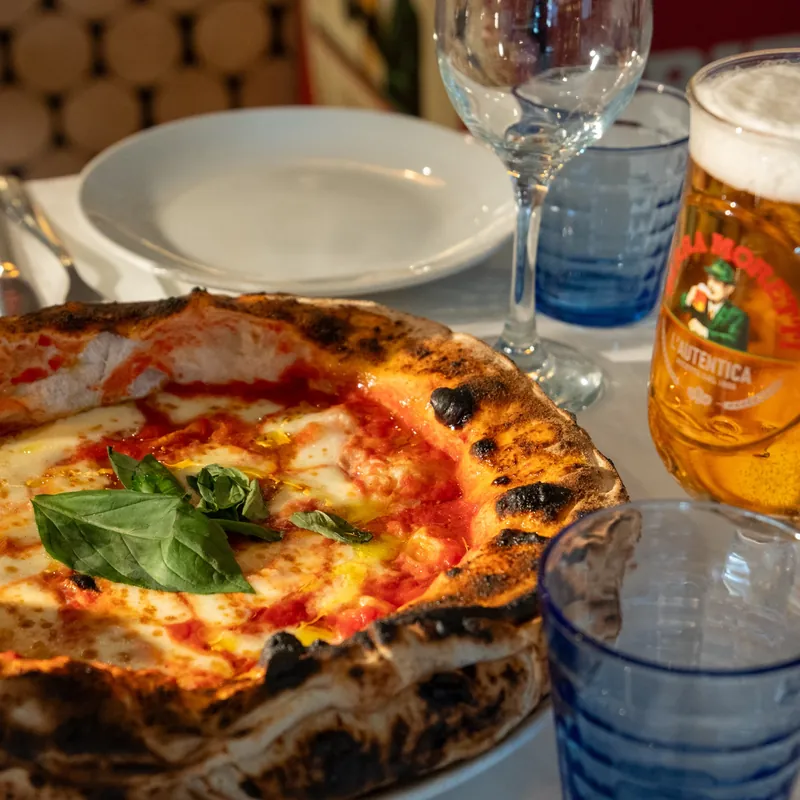 Margherita pizza with fresh basil and a Moretti beer