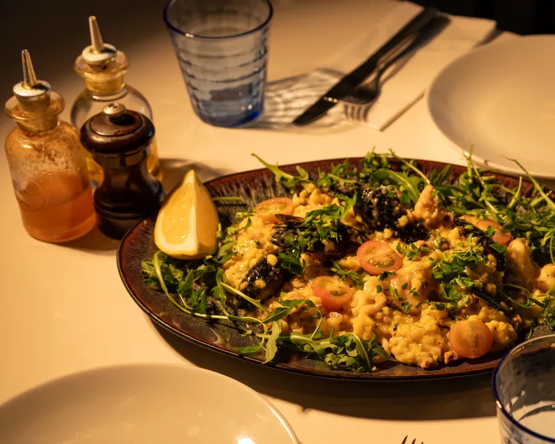 Seafood risotto with mussels, rocket and lemon